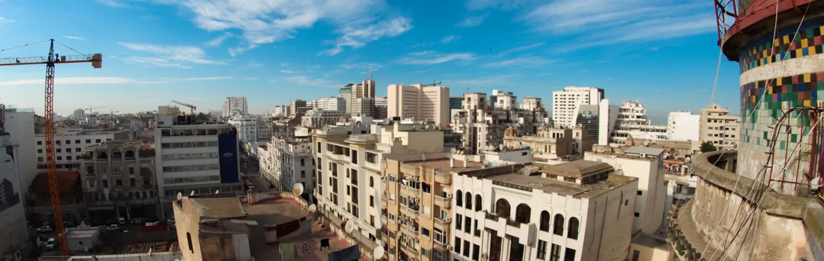 High-angle view of Casablanca's urban skyline under a vibrant blue sky.