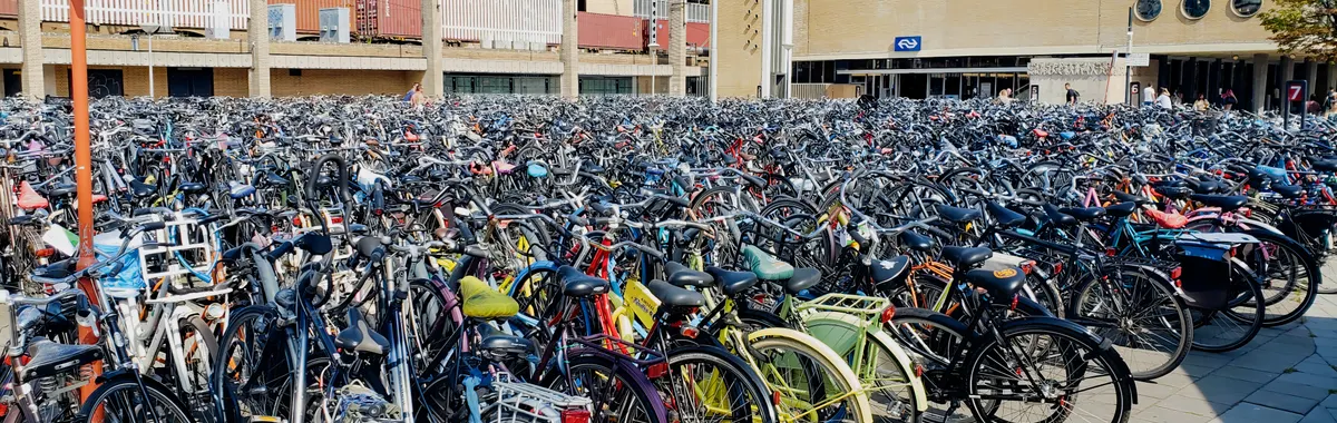 A large collection of bicycles parked outside Eindhoven central station in the Netherlands.