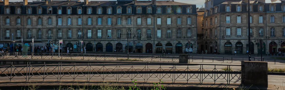 Elegant historic buildings in Bordeaux, France under a clear blue sky.