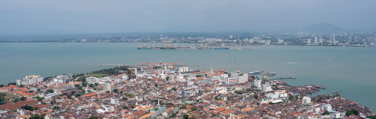 A breathtaking aerial view of Georgetown, Penang highlighting the urban landscape and coastline.