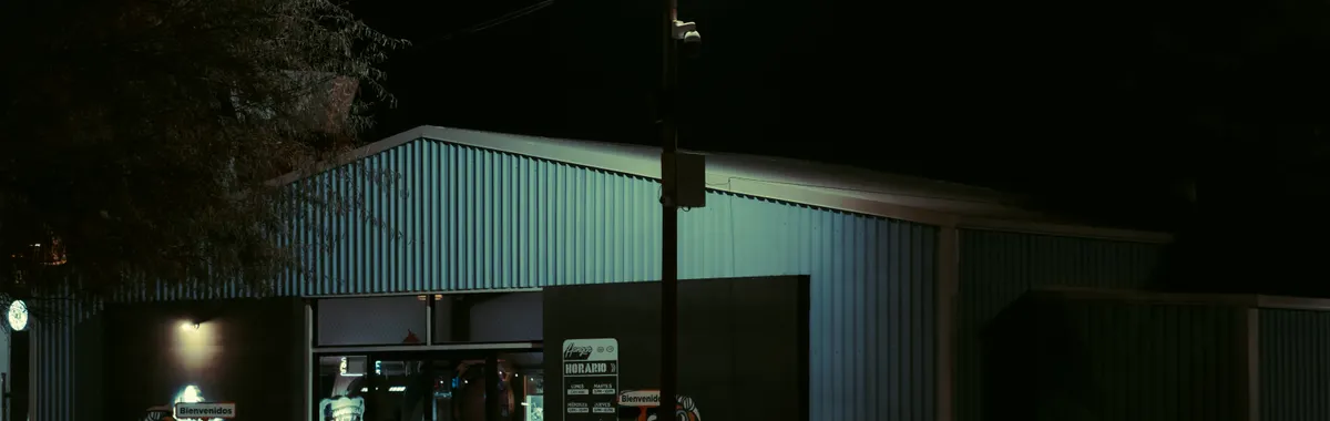 Explore the urban ambiance of a secluded Hermosillo store at night, glowing under streetlights.