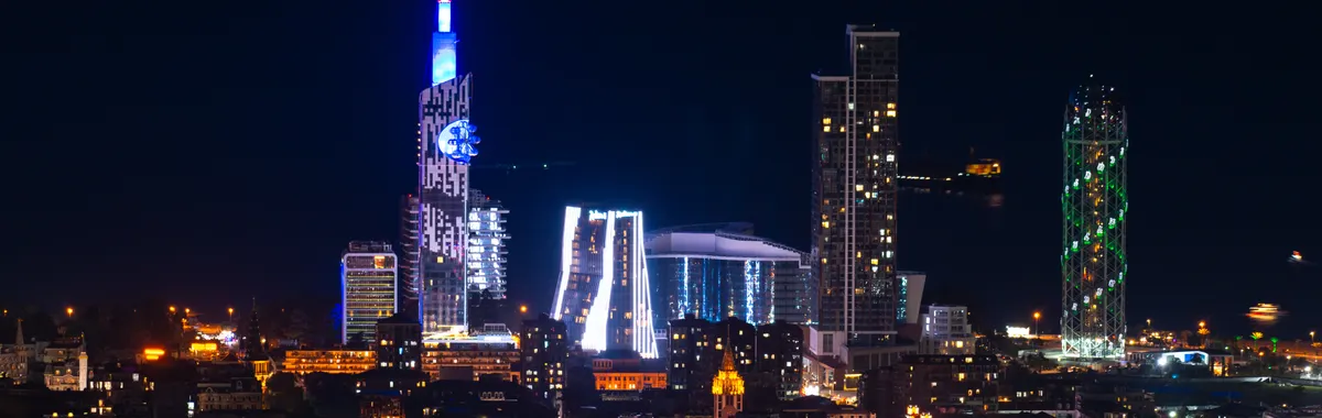 Stunning nighttime view of Batumi's illuminated skyline, showcasing modern architecture and bright city lights.