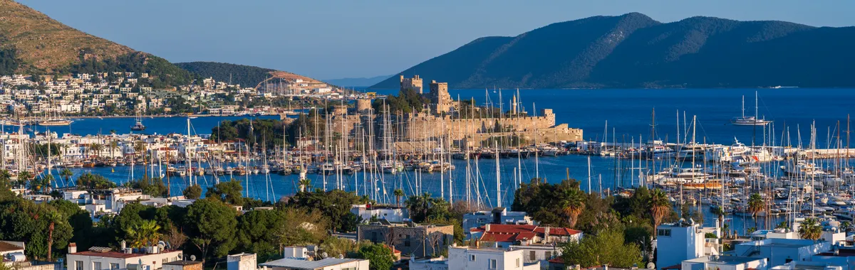 A breathtaking view of Bodrum Castle overlooking the marina and cityscape in Türkiye.