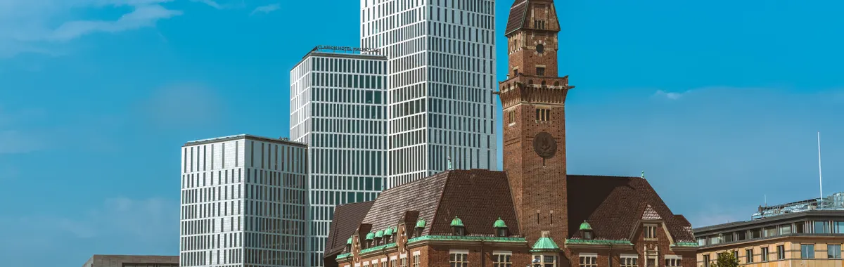 A striking contrast of modern skyscrapers and historic architecture in Malmö, Sweden.