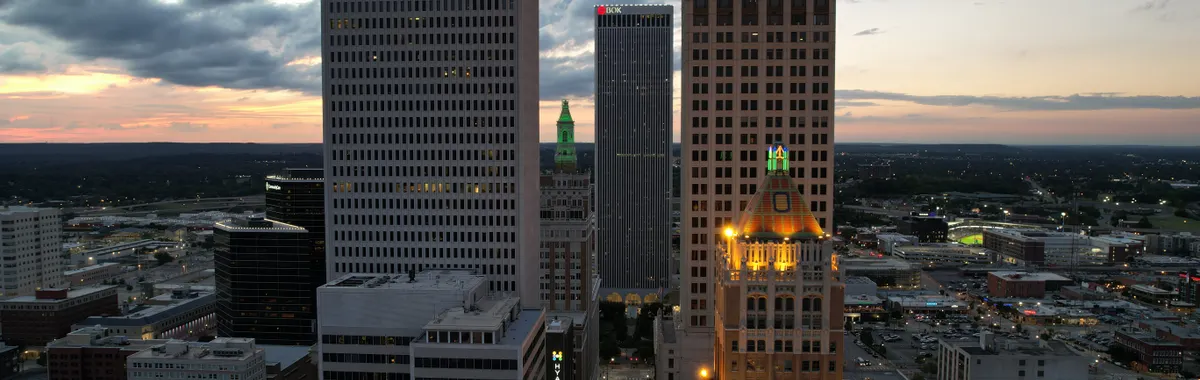 Explore Tulsa's downtown skyline at twilight with stunning architecture and vibrant evening lights.