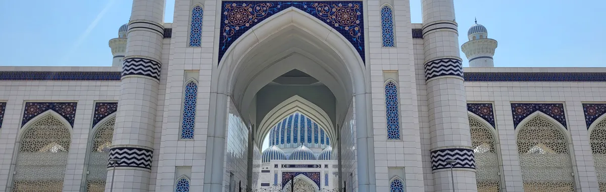 Elegant entrance of a famous mosque in Dushanbe, featuring intricate mosaic designs.