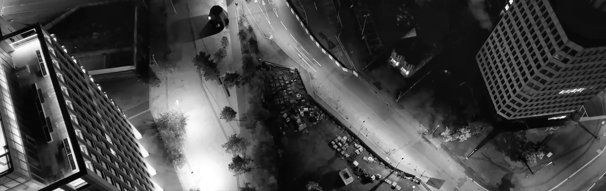 Black and white aerial view of Coventry city at night showcasing urban landscape and architecture.