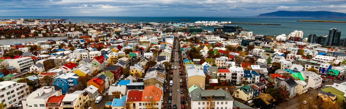 Vibrant aerial view of Reykjavík, Iceland, showcasing its colorful architecture and coastal beauty.