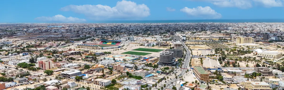 Stunning aerial shot of Nouakchott, Mauritania, showcasing urban sprawl under a bright blue sky.