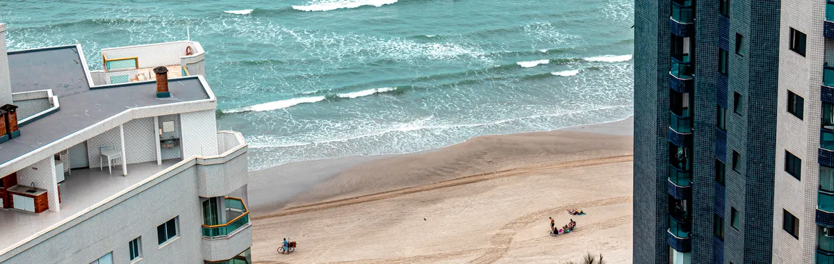 Aerial view of Praia Grande beach with skyscrapers and coastline in São Paulo, Brazil.