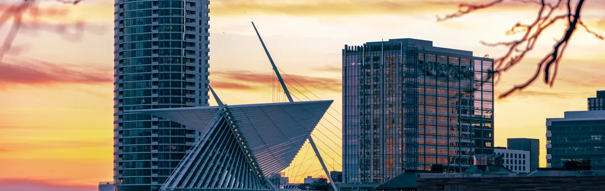 Beautiful sunset view of Milwaukee skyline featuring the iconic Art Museum's architecture.
