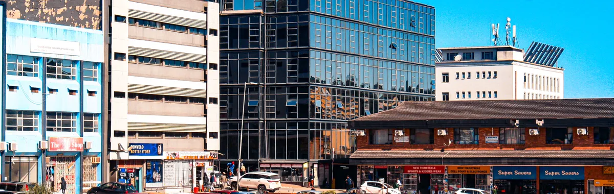 Vibrant cityscape of Matsapha, showcasing modern architecture and bustling streets under a clear blue sky.