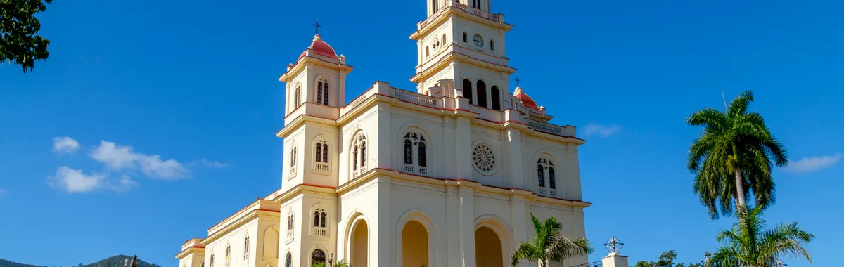 Stunning view of Basilica de Nuestra Señora del Cobre under clear blue skies in El Cobre, Santiago de Cuba.