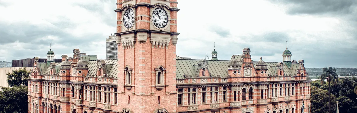 Aerial view of the historic clock tower building in Pietermaritzburg under cloudy skies.