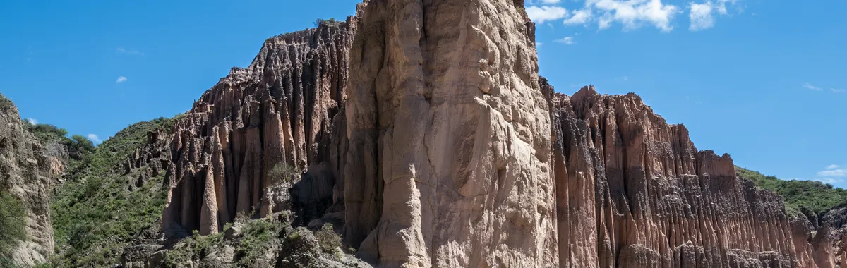 Towering rock formations in San Fernando del Valle de Catamarca, Argentina under a clear blue sky.