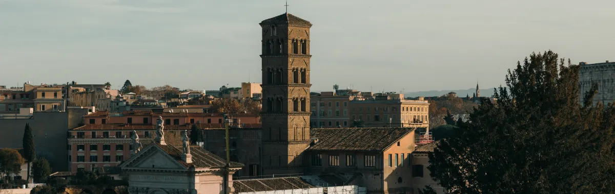 A stunning view of historic Roman architecture bathed in warm sunset light, showcasing iconic structures in Rome, Italy.