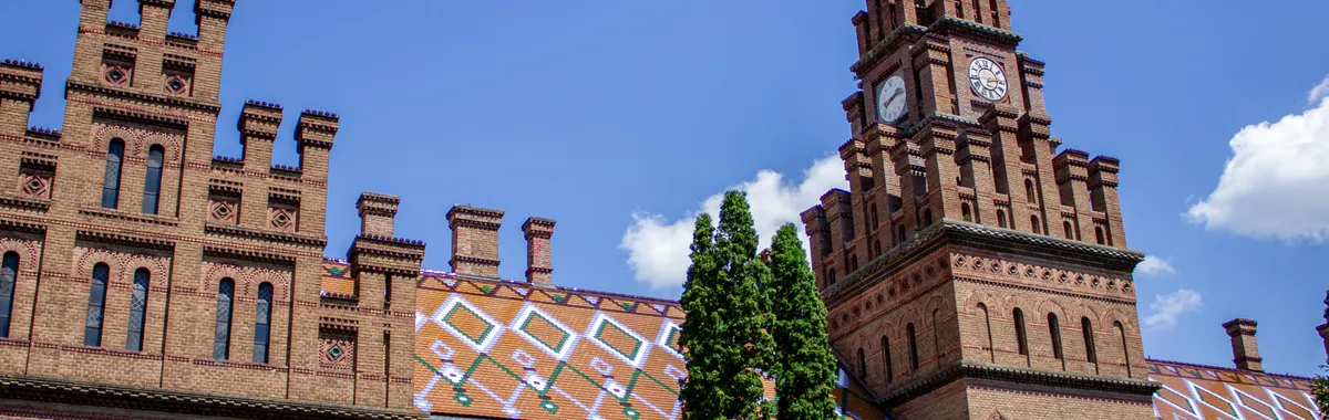 Ornate architecture of Chernivtsi National University under a clear blue sky.