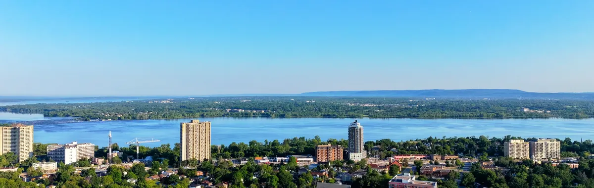 Aerial view of Hamilton, Ontario skyline and Lake Ontario on a clear sunny day.