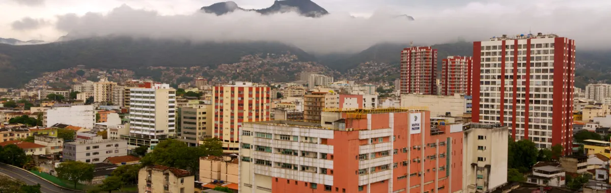 Captivating aerial view of Caracas with urban skyline and misty mountains in the background.