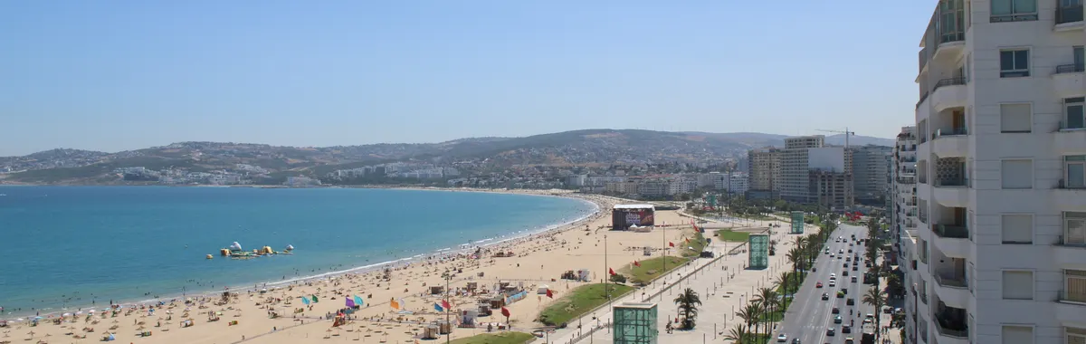 Stunning aerial view of Tangier's sandy beach and bustling city in Morocco.