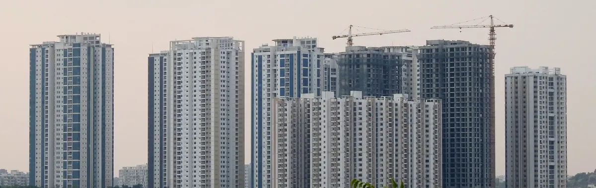 Panoramic view of modern skyscrapers in Hyderabad, India featuring urban development and construction cranes.