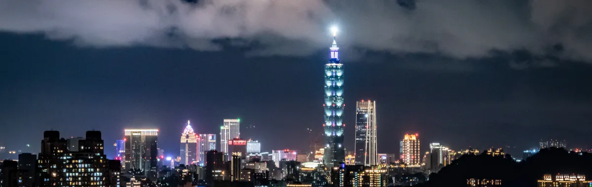 Vibrant skyline of Taipei with the iconic Taipei 101 highlighted at night.