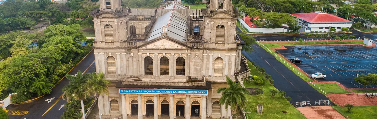 Aerial shot of the Old Cathedral of Managua, showcasing its historic architecture and surrounding cityscape.