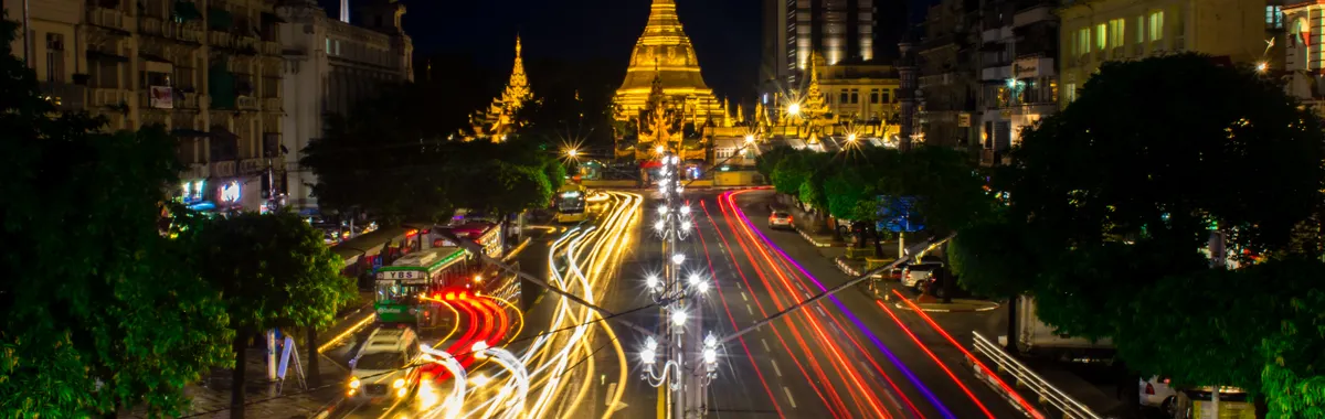 A stunning night scene of traffic motion around the illuminated Sule Pagoda in Yangon, Myanmar.