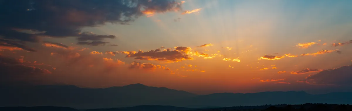 Breathtaking Colorado Springs sunset with vibrant clouds and mountain silhouette.
