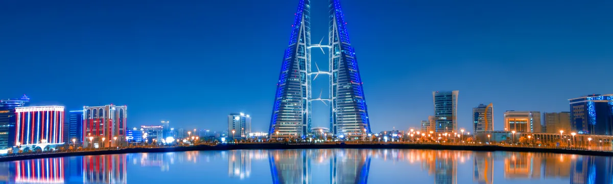 בחריין: Stunning night view of Bahrain World Trade Center with clear water reflections and modern skyline.
