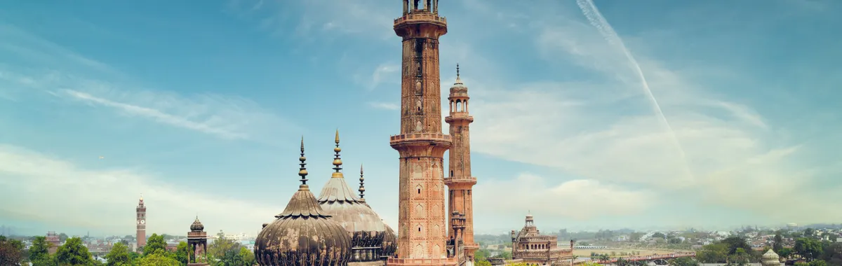 A striking view of a historic mosque with minarets in Lucknow, India, showcasing architectural beauty.