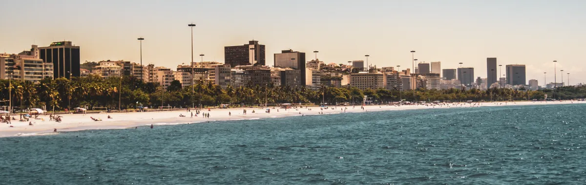 Beautiful beachfront in Rio de Janeiro with cityscape and ocean views.