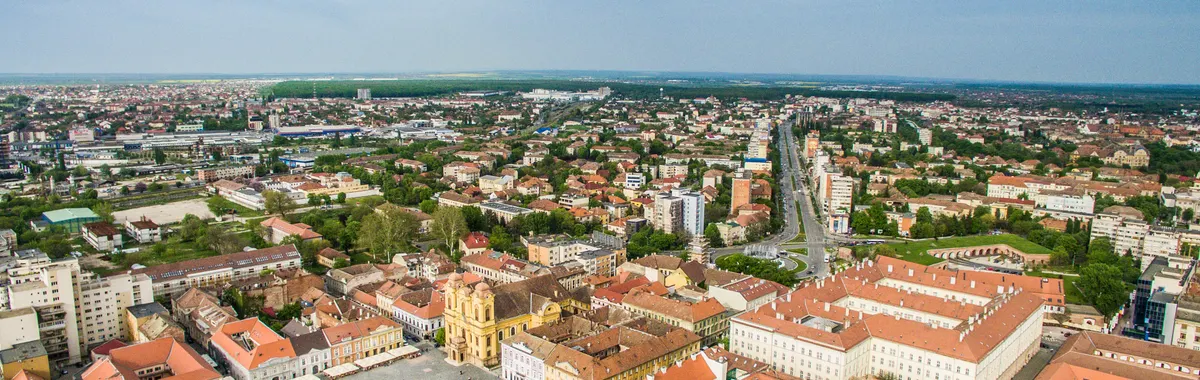 Drone shot of Timișoara's vibrant cityscape showcasing historic architecture and urban layout.