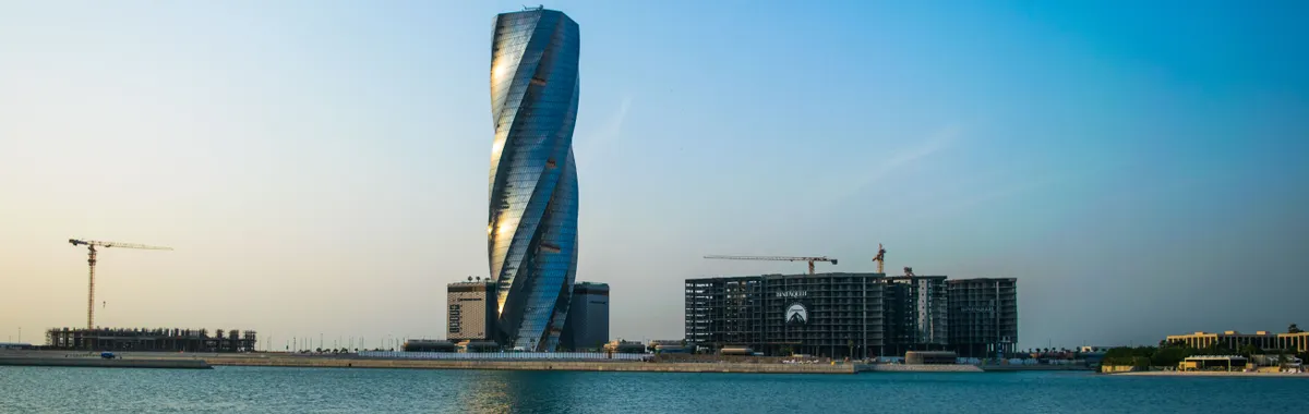 Stunning view of the United Tower in Bahrain's skyline by the water.