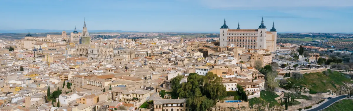 Stunning aerial view of Toledo, Spain featuring the Alcazar and historical architecture.
