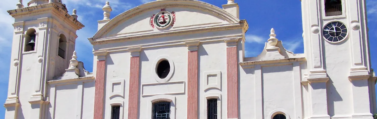 Front view of historic cathedral in Asunción, Paraguay with clear blue sky.