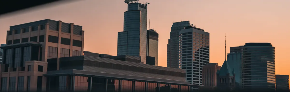 Captivating view of Minneapolis skyline during sunset, showcasing modern architecture in a serene twilight.
