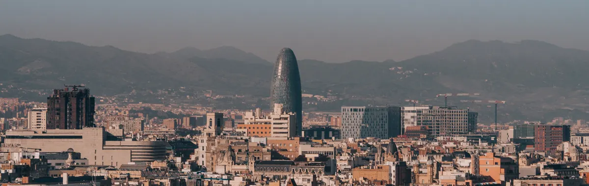 A panoramic view of Barcelona's skyline with Torre Glòries during a clear morning.