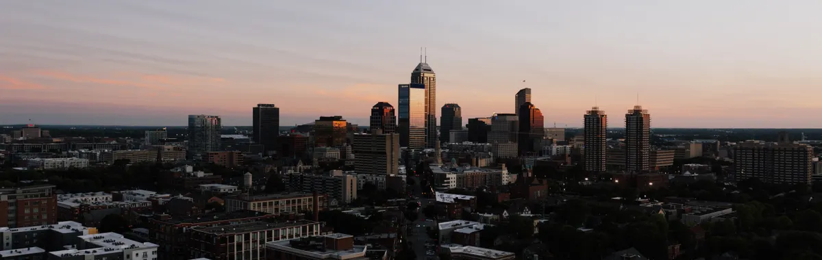 A stunning aerial view of Indianapolis skyline during sunset, showcasing urban architecture.