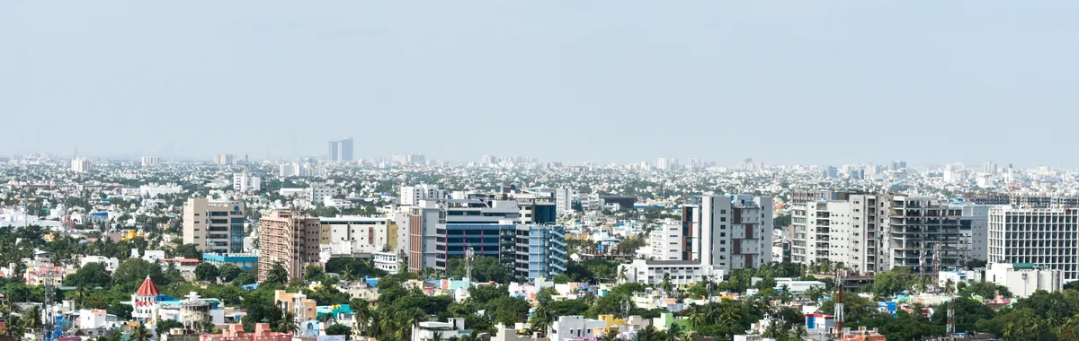 Aerial view of colorful high-rise buildings in Chennai, India, under a clear sky.